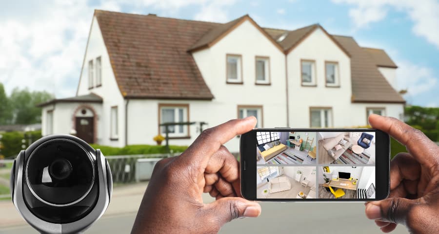 Man holding phone and checking streams from surveillance cameras